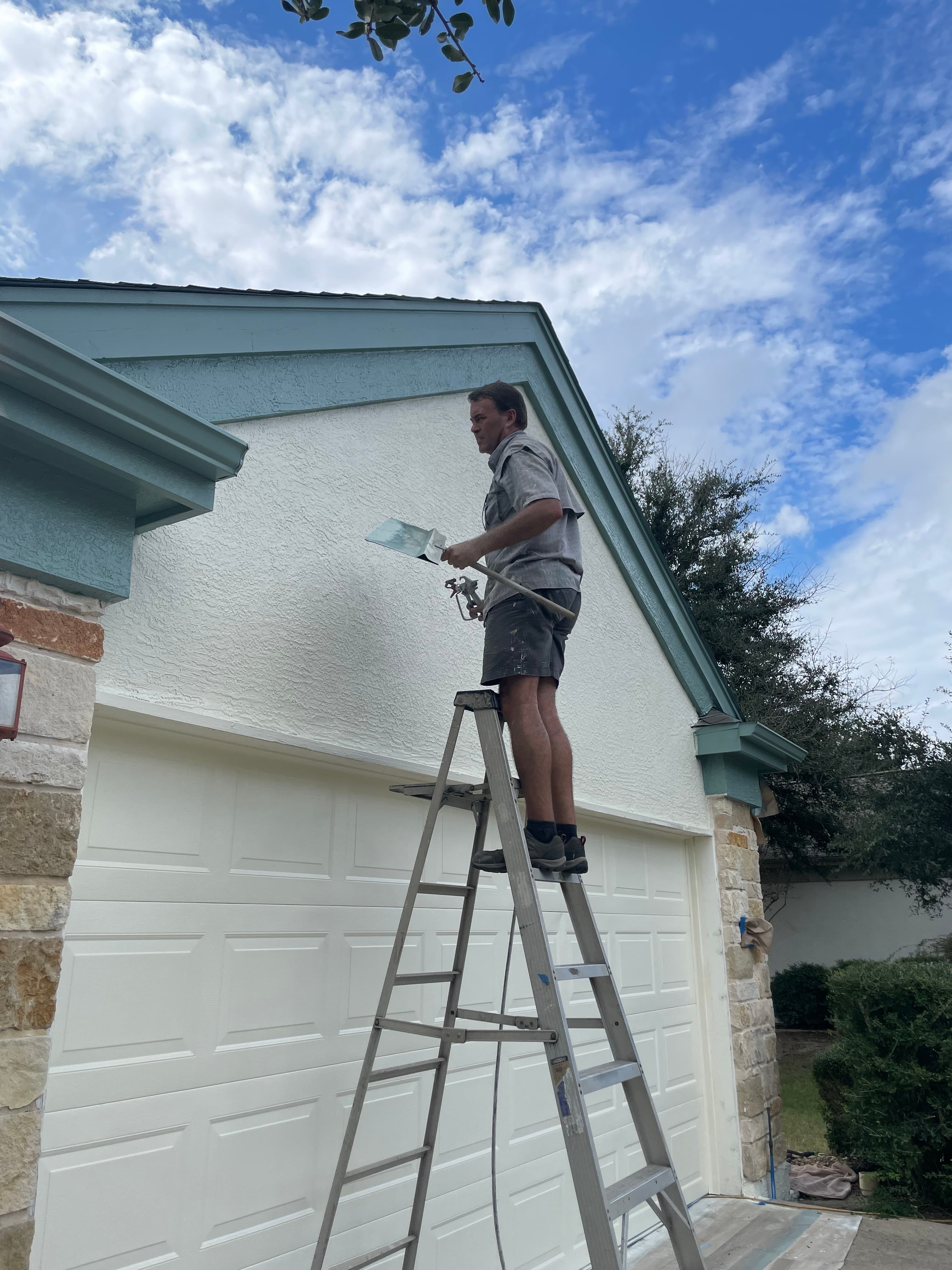 Kevin painting outside trim